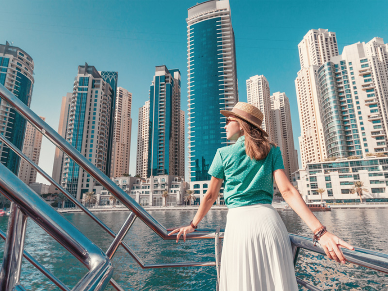 a tourist viewing skyline of dubai with burj al arab, burj khalifa, on a dubai city sightseeing tour