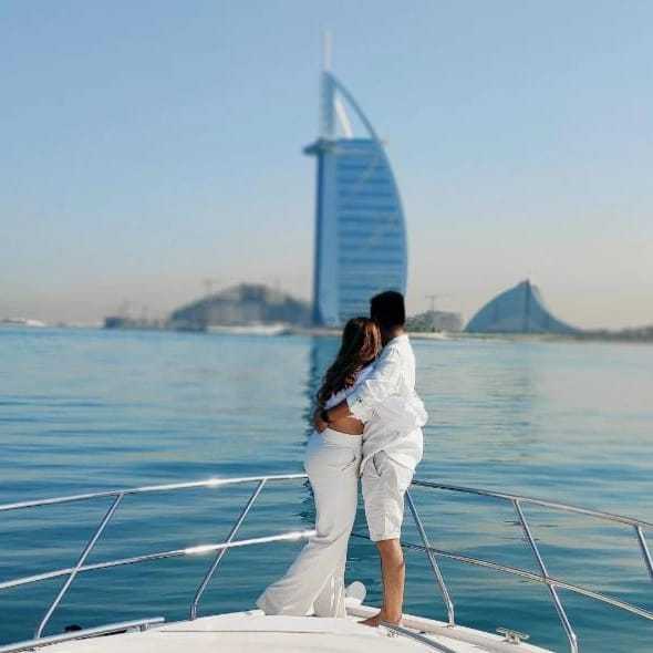 romantic couple enjoying the views of burj al arab, palm jumeirah, bluewaters island, world island on ROMANTIC YACHT CHARTER DUBAI