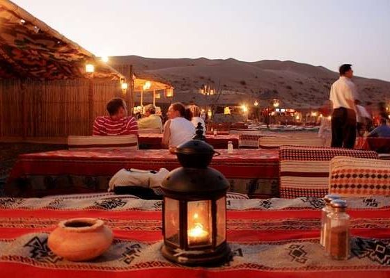 tourists enjoying dune, bashing, camel rides, bbq buffet and private seating on a private desert safari in dubai